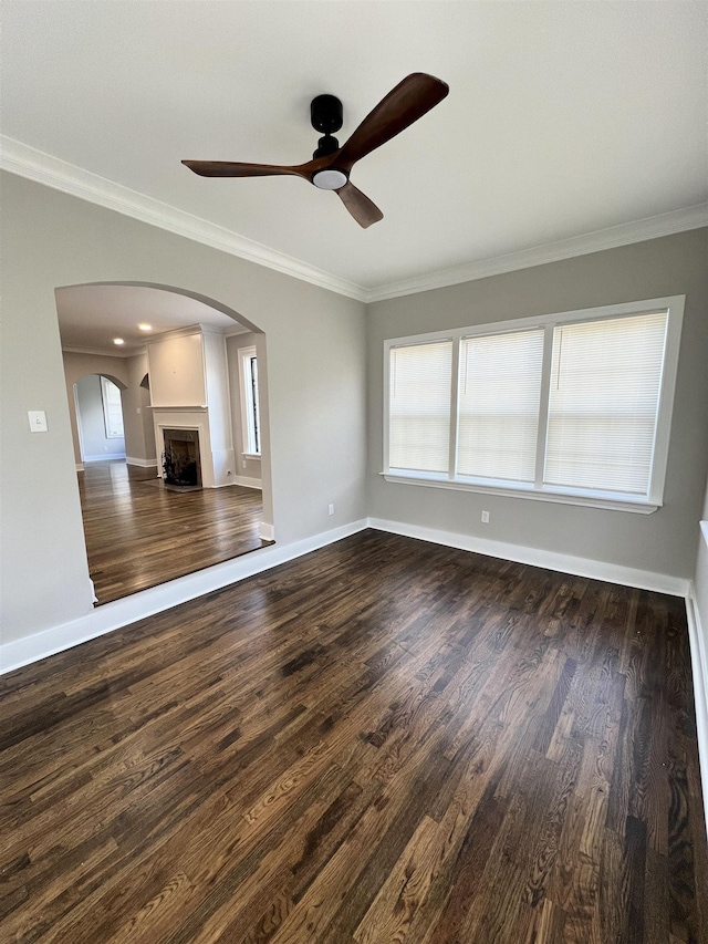 unfurnished living room featuring ceiling fan, dark hardwood / wood-style flooring, and crown molding