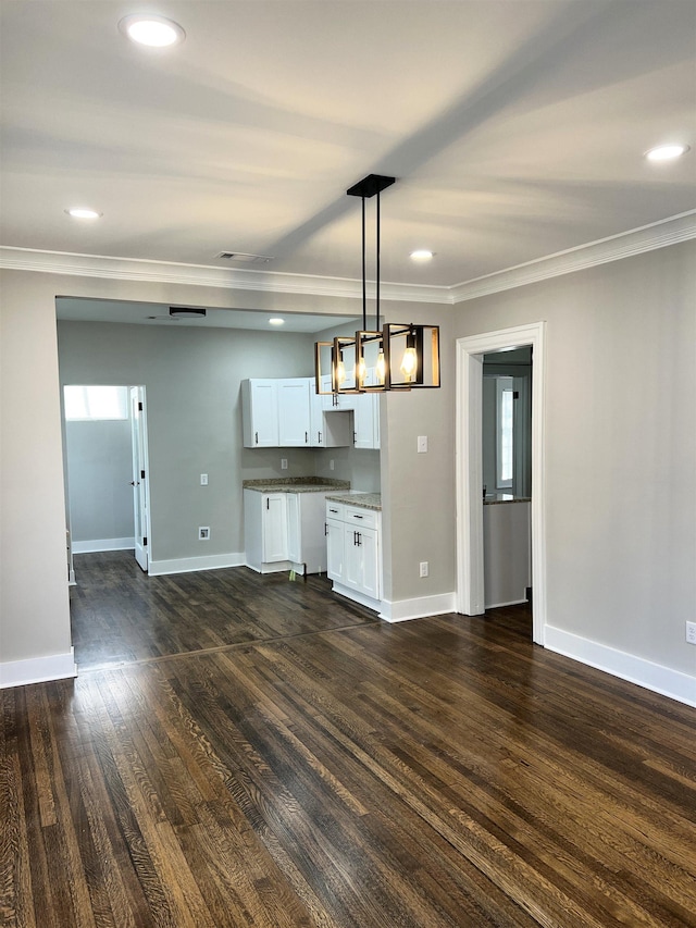 interior space featuring dark hardwood / wood-style floors and crown molding