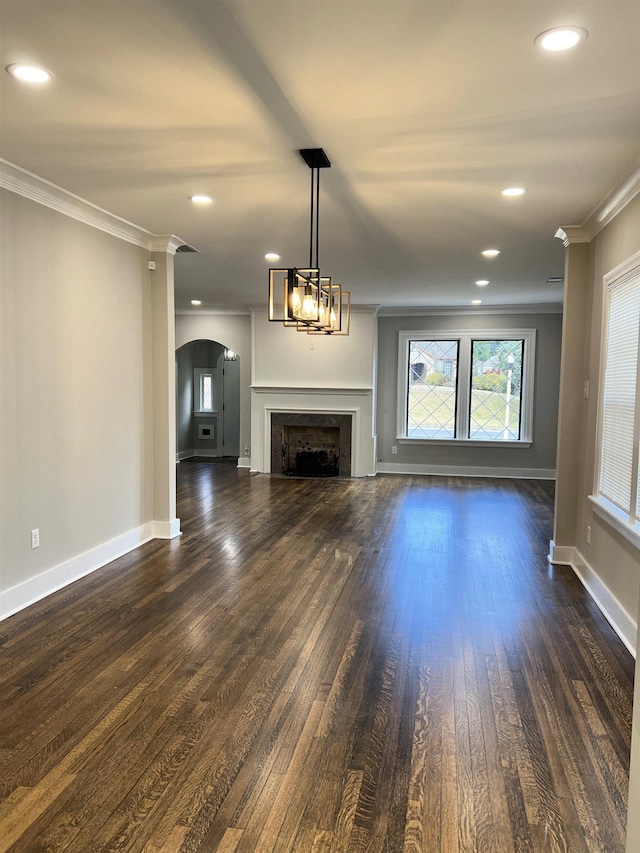 unfurnished living room with dark wood-type flooring and ornamental molding