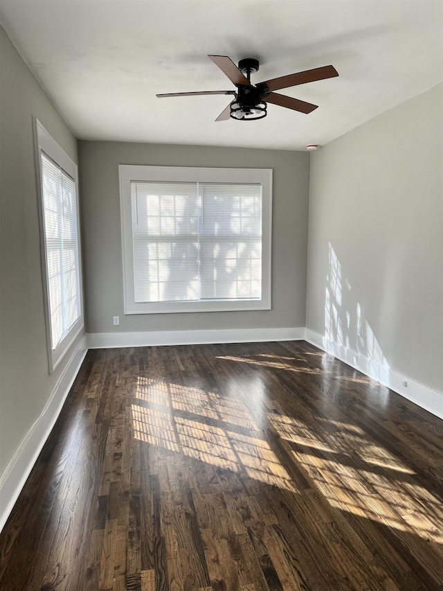 spare room with ceiling fan and dark hardwood / wood-style flooring