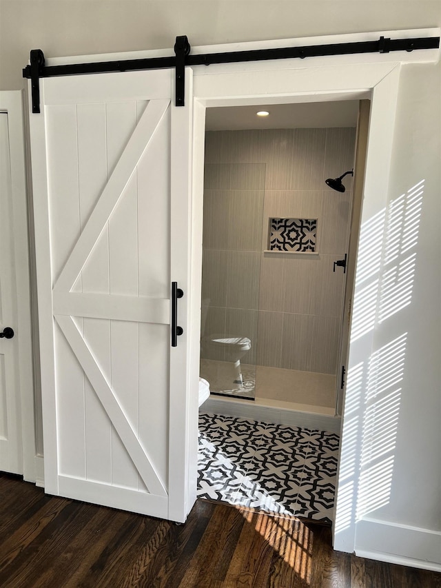 bathroom featuring tiled shower and hardwood / wood-style flooring