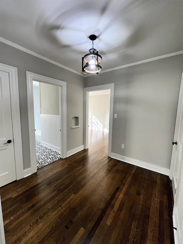 unfurnished dining area featuring dark hardwood / wood-style floors and ornamental molding