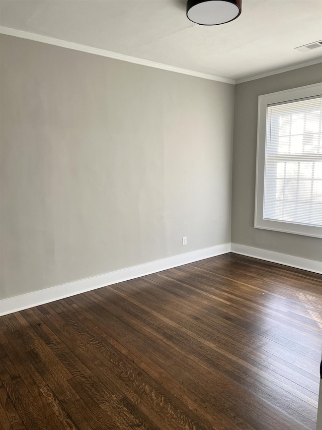 unfurnished room with dark hardwood / wood-style floors and crown molding