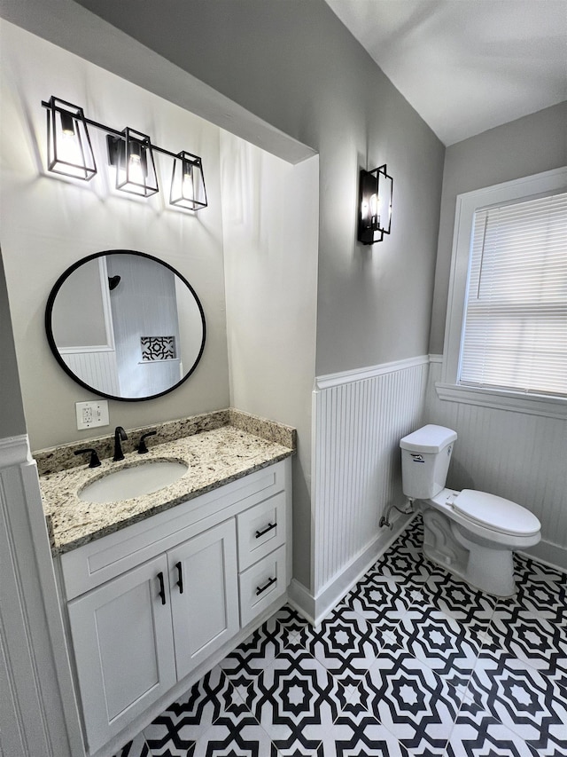 bathroom featuring tile patterned floors, vanity, and toilet