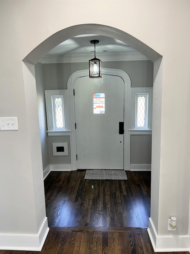 foyer entrance featuring dark hardwood / wood-style floors and ornamental molding