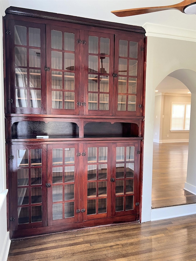 details with hardwood / wood-style floors and crown molding