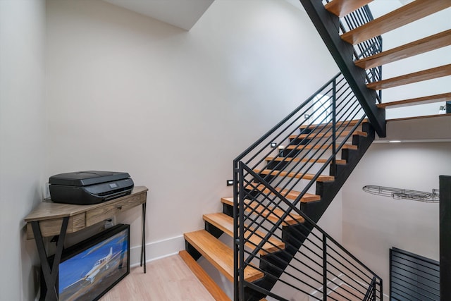 stairs featuring hardwood / wood-style floors