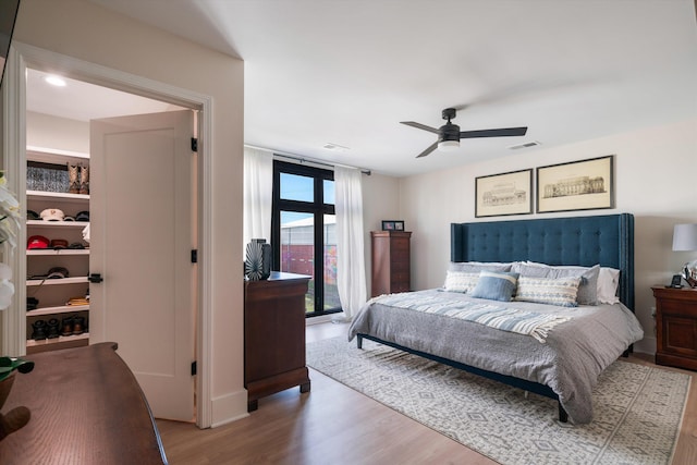 bedroom featuring access to exterior, hardwood / wood-style flooring, and ceiling fan