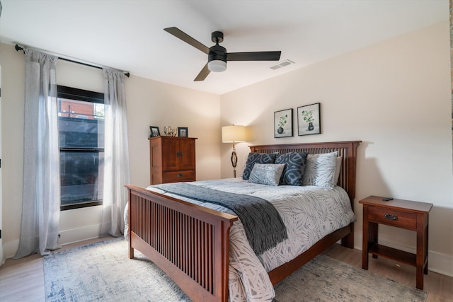 bedroom with ceiling fan and light wood-type flooring