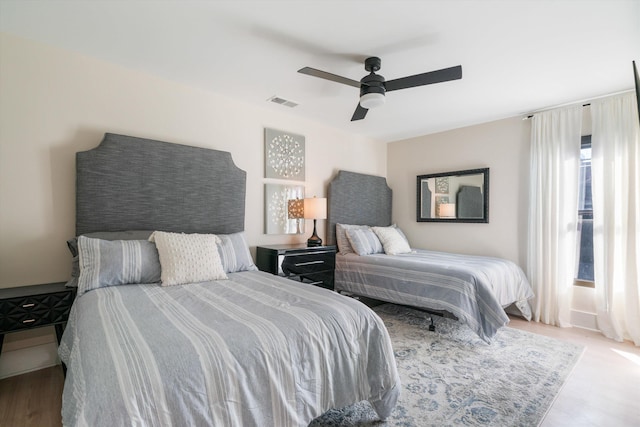 bedroom with ceiling fan and light hardwood / wood-style flooring