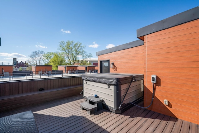 wooden deck with a hot tub