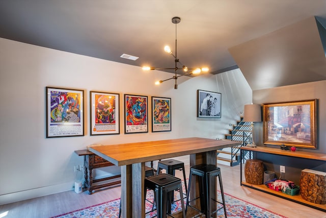 dining space featuring a notable chandelier and light hardwood / wood-style floors