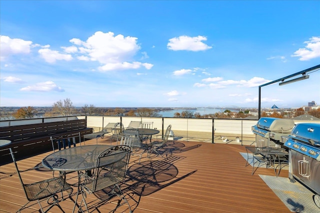 wooden deck featuring grilling area and a water view