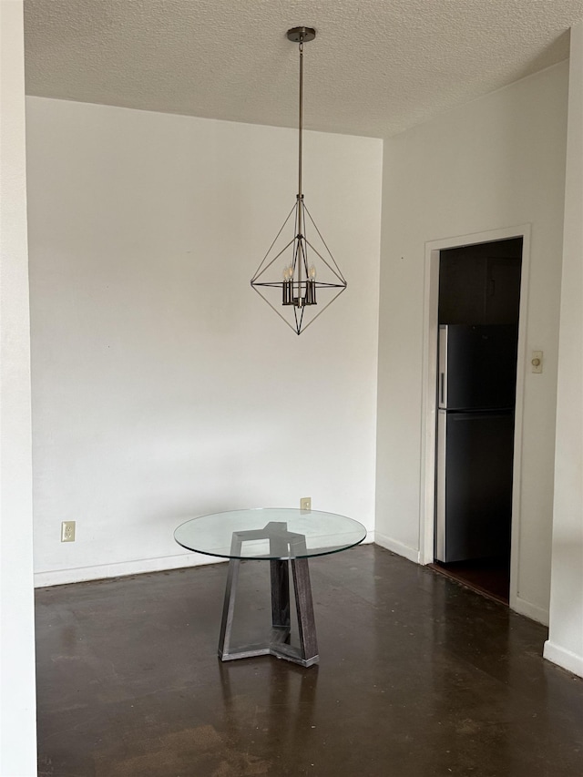 unfurnished dining area with an inviting chandelier and a textured ceiling