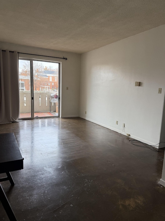 spare room with a textured ceiling