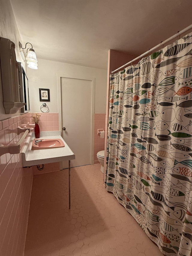 bathroom featuring toilet, tile walls, tile patterned floors, and vanity