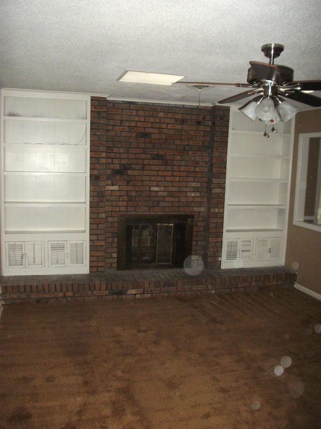 unfurnished living room with a fireplace, dark carpet, a textured ceiling, and ceiling fan