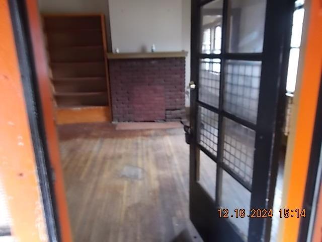 hallway with hardwood / wood-style floors