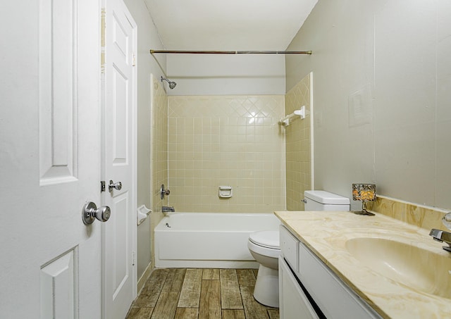 full bathroom featuring tiled shower / bath, toilet, vanity, and hardwood / wood-style flooring