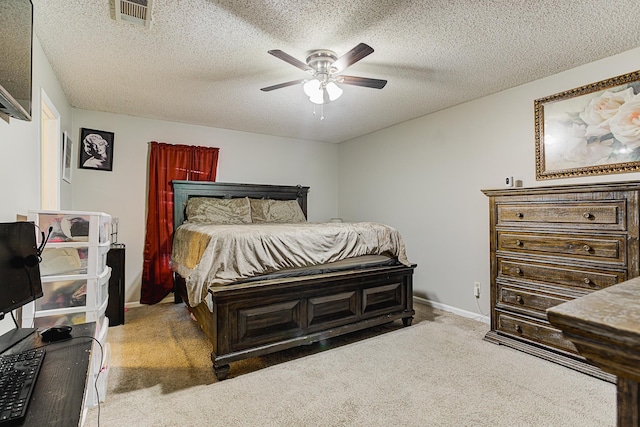 carpeted bedroom featuring a textured ceiling and ceiling fan