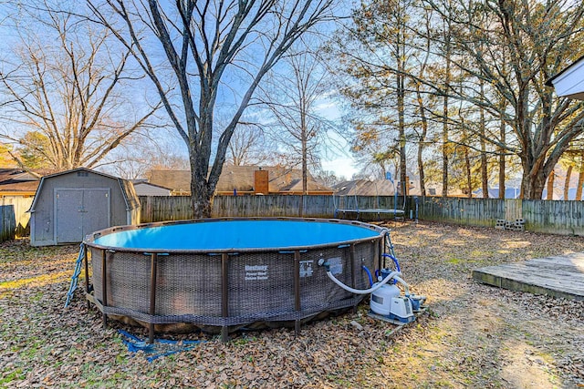 view of yard featuring a fenced in pool and a storage shed