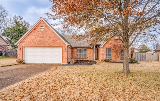 view of front of home featuring a front yard and a garage