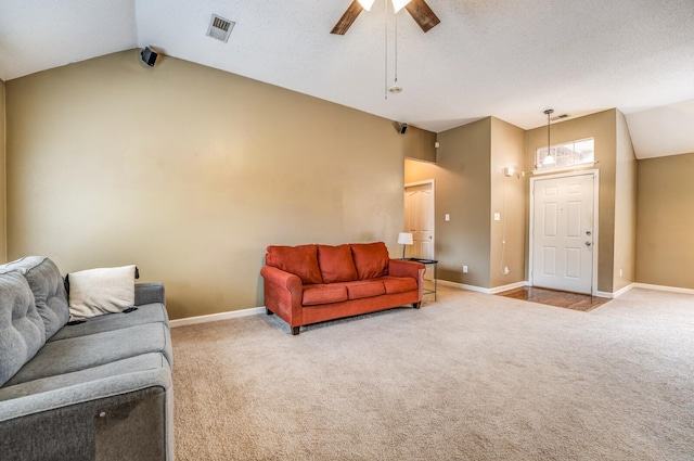 living room with ceiling fan, light colored carpet, and vaulted ceiling