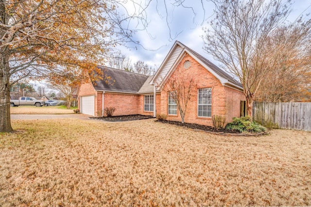 view of front of property featuring a garage and a front lawn