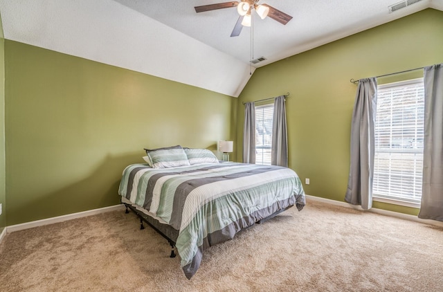 carpeted bedroom with vaulted ceiling and ceiling fan