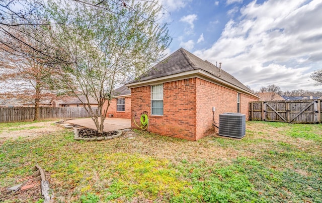 back of property featuring cooling unit, a patio area, and a lawn