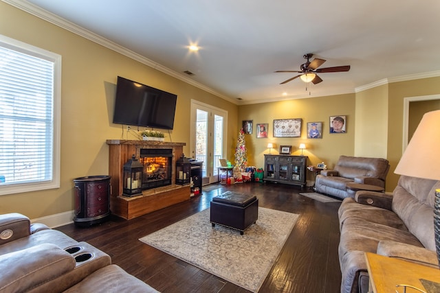 living room with dark hardwood / wood-style flooring, plenty of natural light, and crown molding