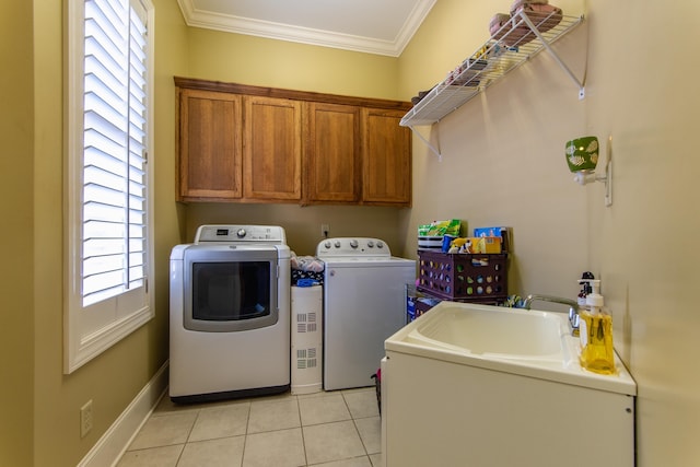 laundry area featuring cabinets, ornamental molding, washer and clothes dryer, sink, and light tile patterned flooring