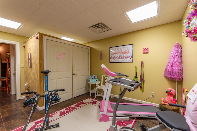 workout area featuring a paneled ceiling