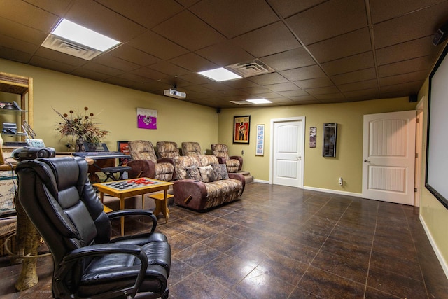 living room featuring a drop ceiling