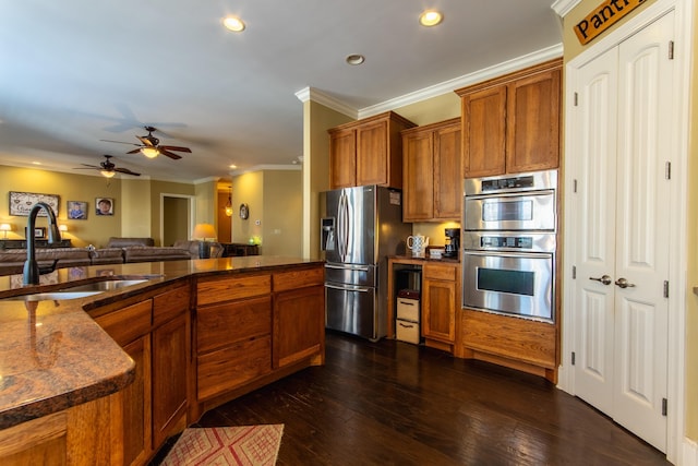 kitchen featuring sink, crown molding, ceiling fan, dark hardwood / wood-style flooring, and stainless steel appliances