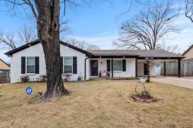 ranch-style house with a front yard and a carport