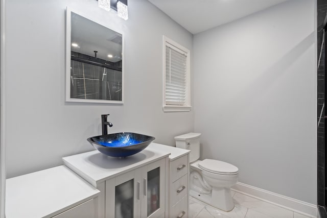 bathroom with a shower, vanity, and toilet