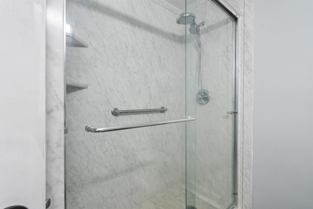 bathroom featuring a shower with shower door