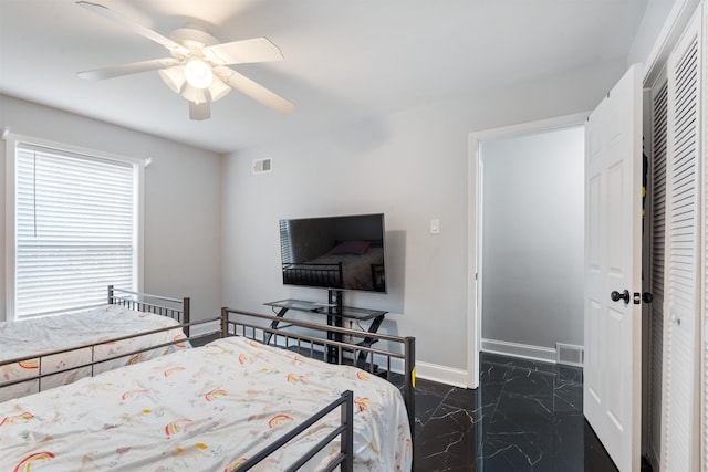 bedroom featuring ceiling fan and a closet