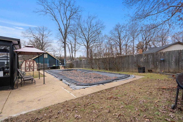 view of swimming pool with a gazebo, a patio area, and a storage shed