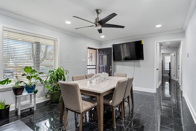 dining space with ceiling fan and crown molding