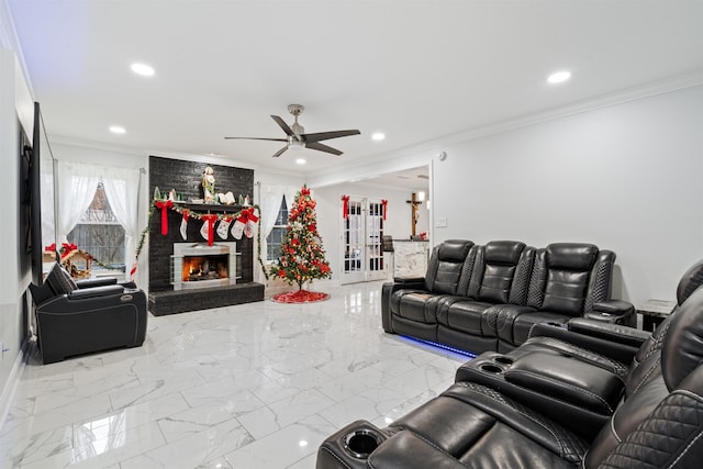 living room featuring crown molding, ceiling fan, and a brick fireplace