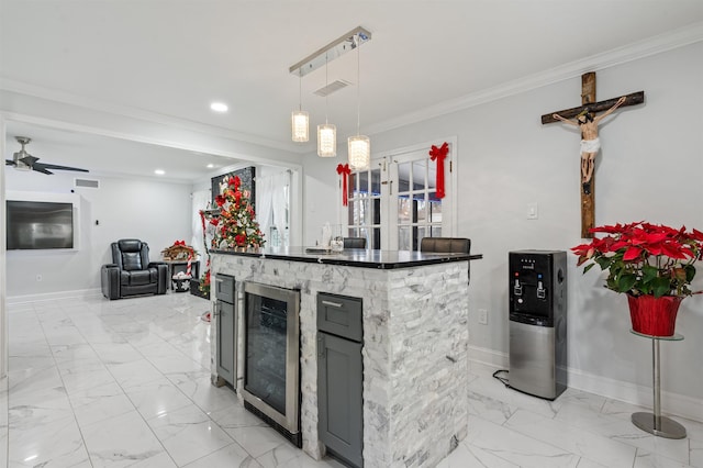 kitchen featuring a stone fireplace, hanging light fixtures, crown molding, wine cooler, and ceiling fan