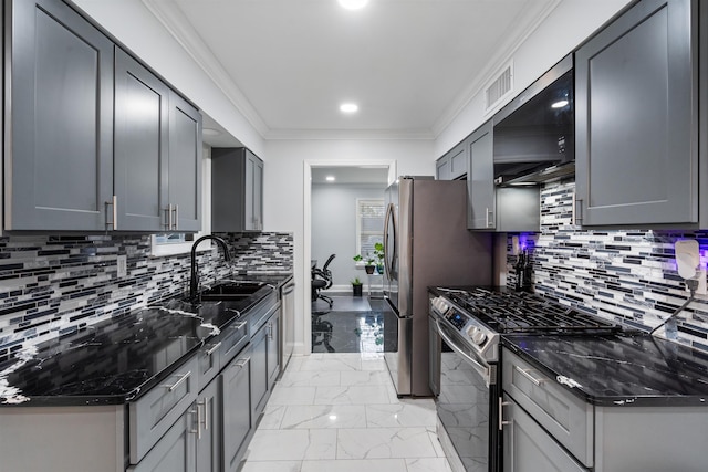 kitchen featuring decorative backsplash, appliances with stainless steel finishes, crown molding, and gray cabinetry