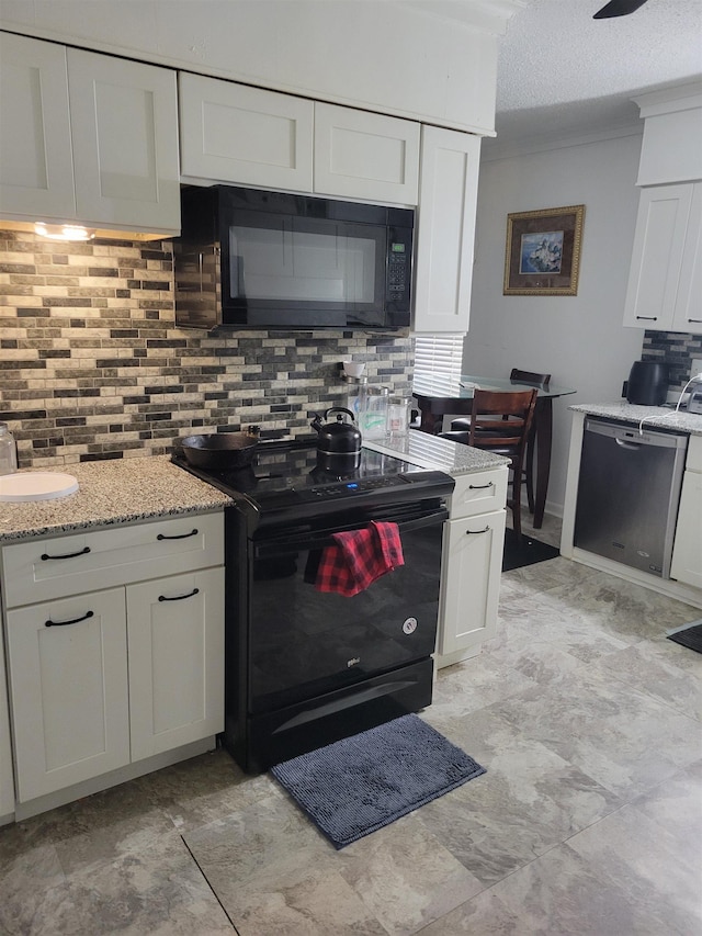 kitchen with light stone counters, backsplash, a textured ceiling, white cabinets, and black appliances