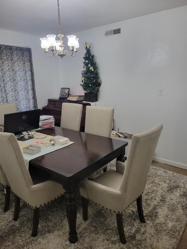 dining area featuring an inviting chandelier