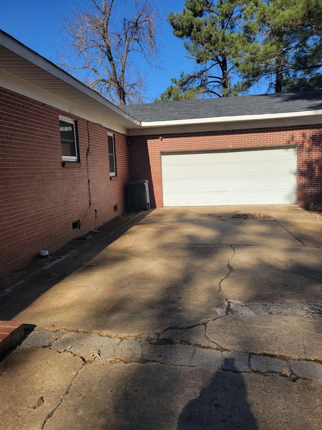 view of property exterior featuring central AC and a garage