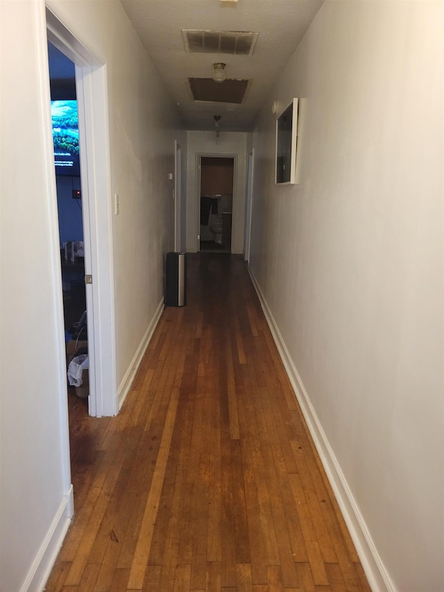 corridor featuring dark hardwood / wood-style flooring