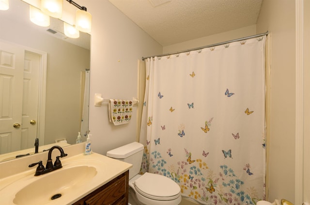 bathroom featuring vanity, curtained shower, toilet, and a textured ceiling