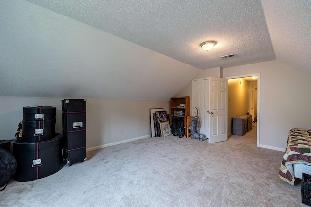 additional living space with lofted ceiling, carpet floors, and a textured ceiling